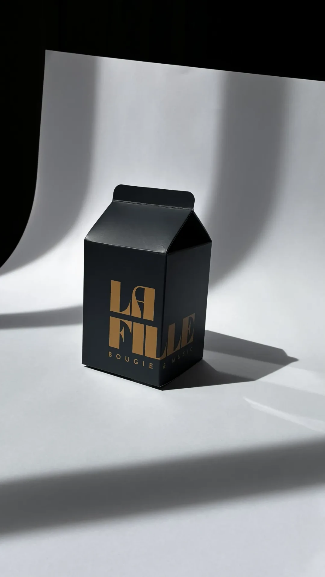 Black La Fille Milk Box carton in hard sunlight.