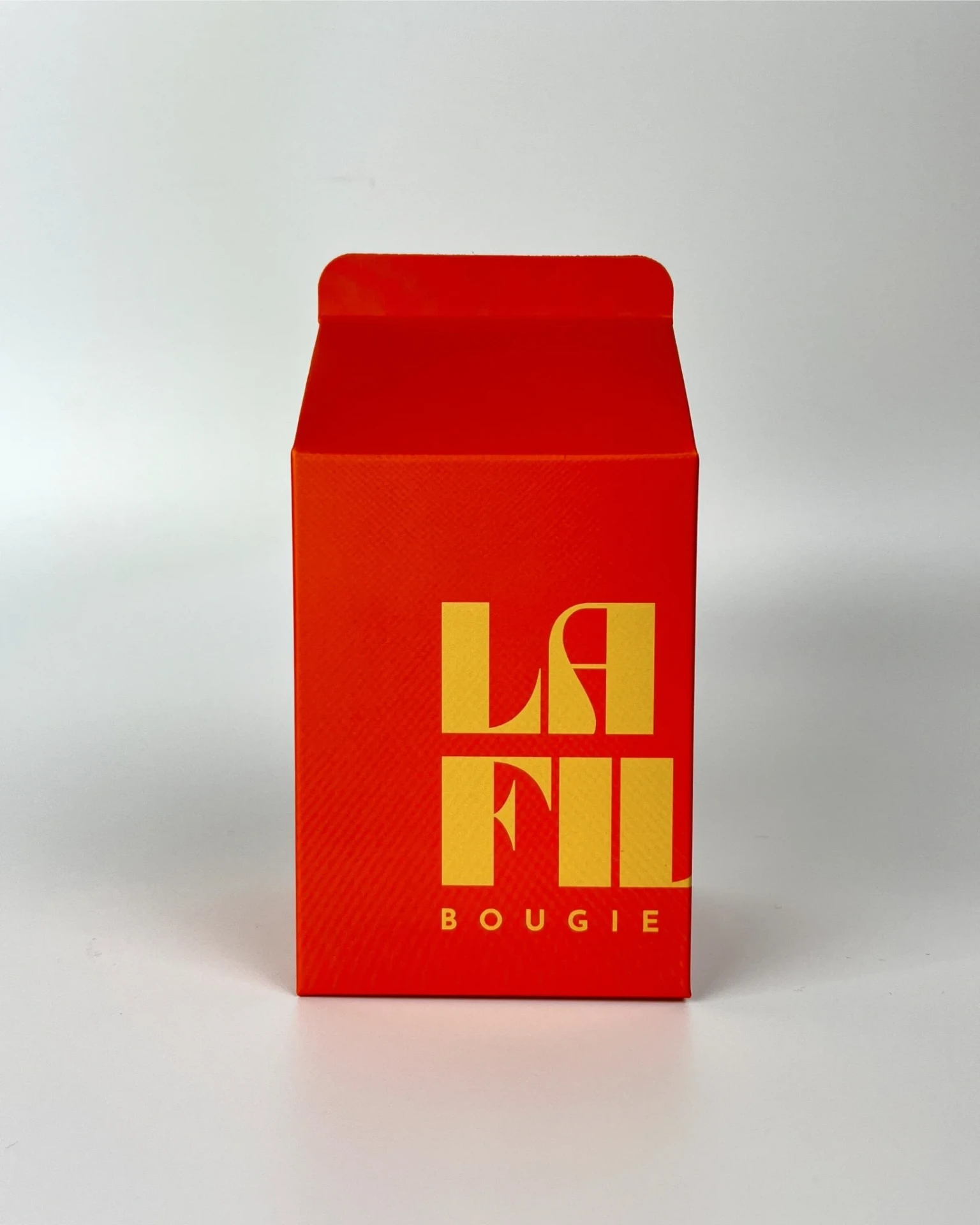 Front view of the orange and vanilla La Fille Milk Box packaging for the ORANGE BLOSSOM scented candle.
