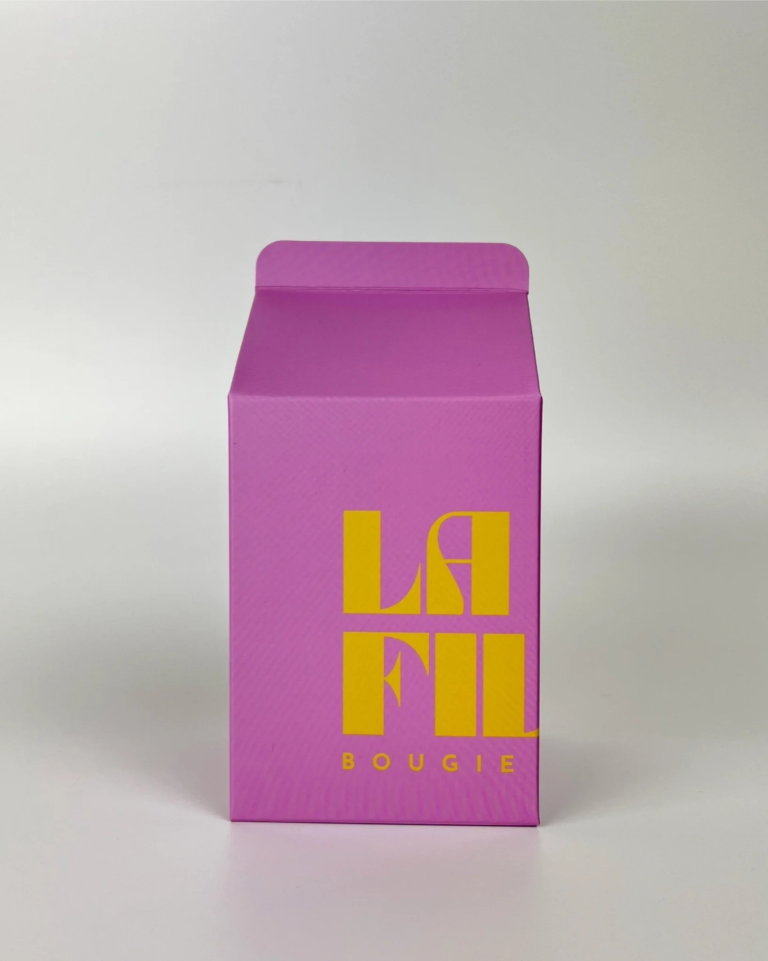Front view of the lilac and vanilla La Fille Milk Box packaging for the FIG scented candle.