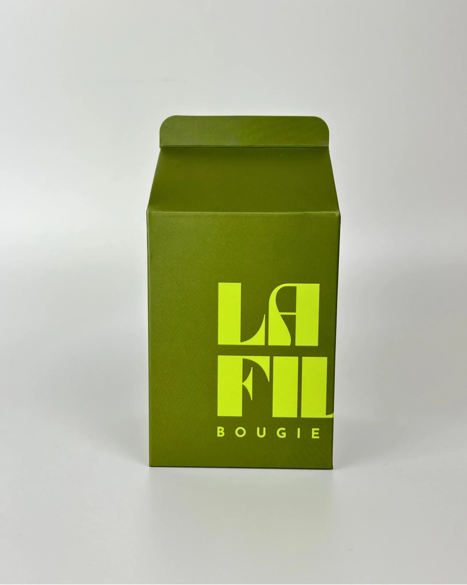Front view of the dark green and apple green La Fille Milk Box packaging for the SANDALWOOD & PALO SANTO scented candle.